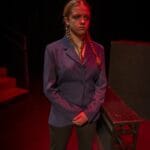 Sarah Genne acting in a dramatic scene on stage
