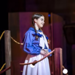 Sarah Genne acting in a dramatic scene on stage