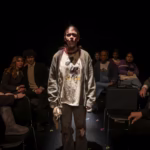 Sarah Genne acting in a dramatic scene on stage